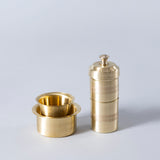 brass coffee filter with mini glass and bowl.