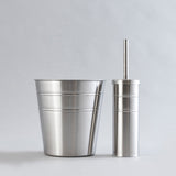 Shiny stainless steel waste bin and brush holder combo.