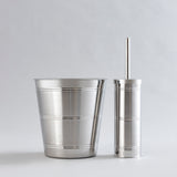 Shiny stainless steel waste bin and brush holder combo.