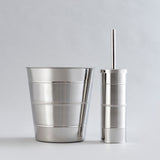 Shiny stainless steel waste bin and brush holder combo.